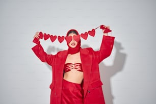 uma mulher com uma roupa vermelha com corações na cabeça