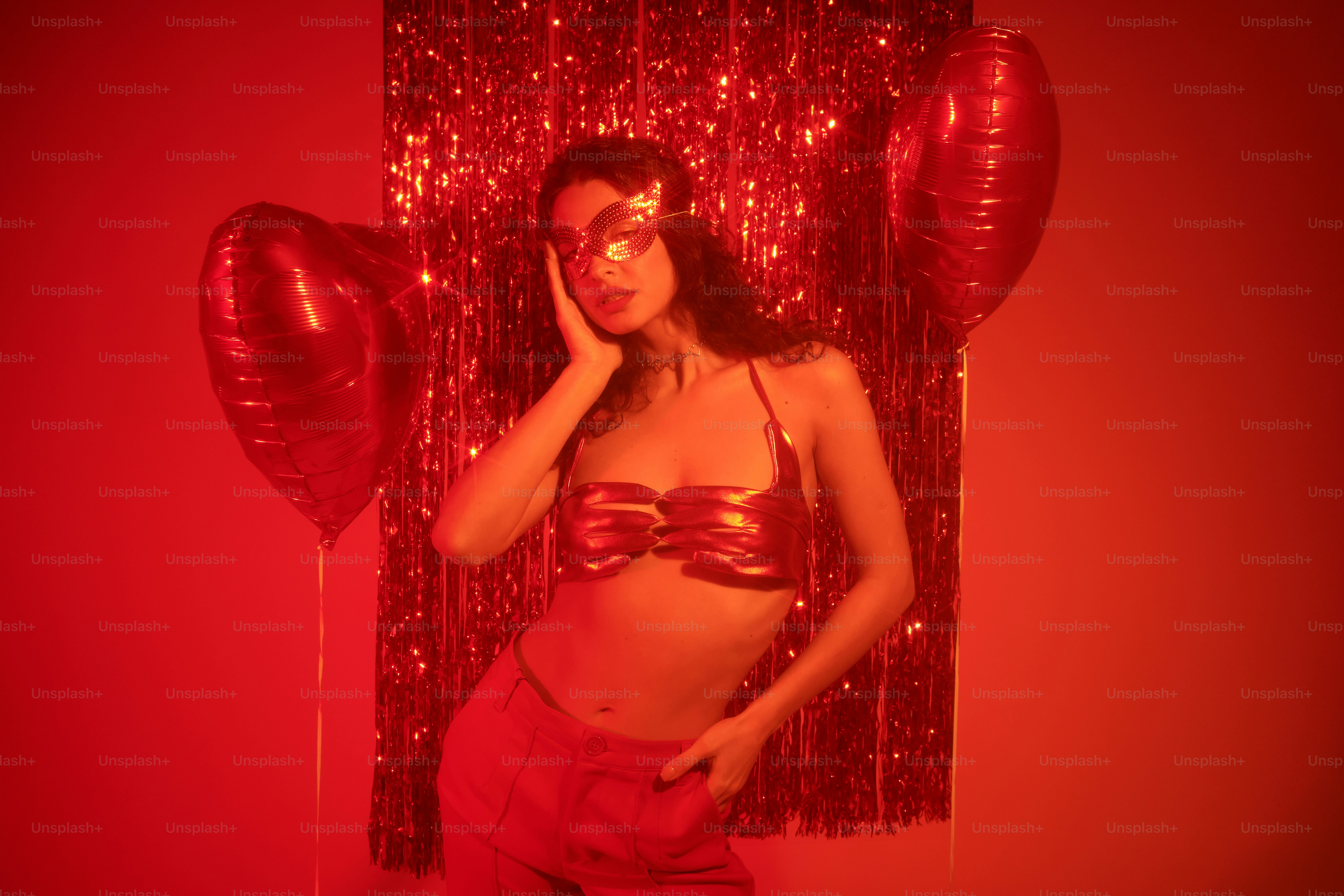 a woman in a bikini posing in front of balloons