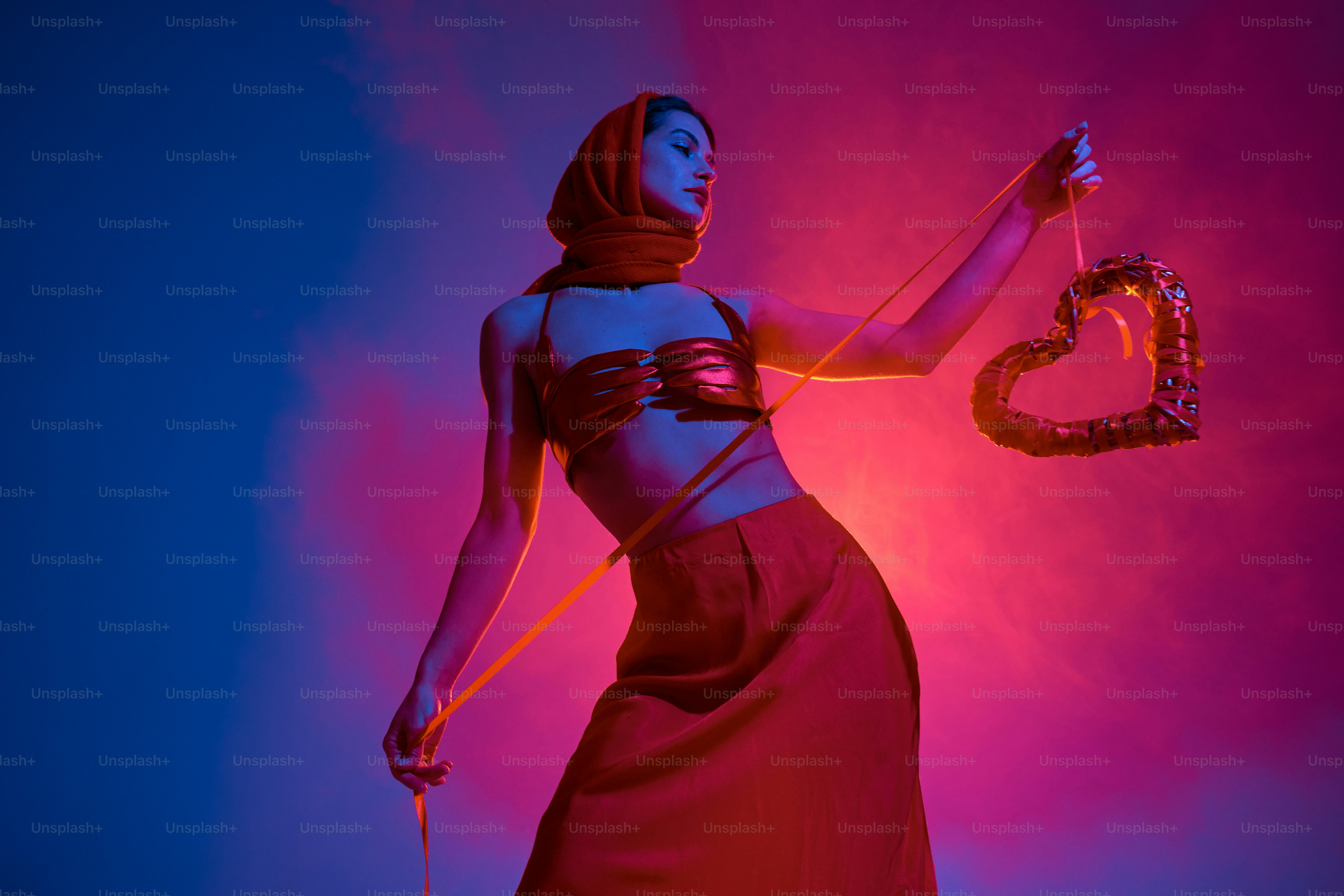 a woman in a red dress holding a snake