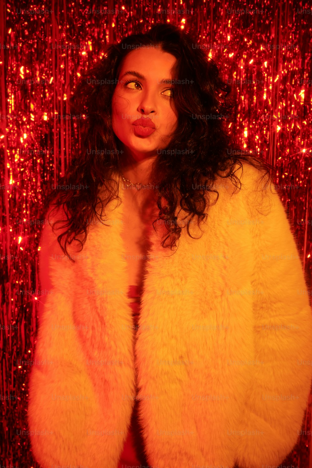 a woman in a fur coat posing for a picture