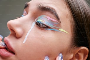 a woman with painted eyebrows and eyeliners on her face