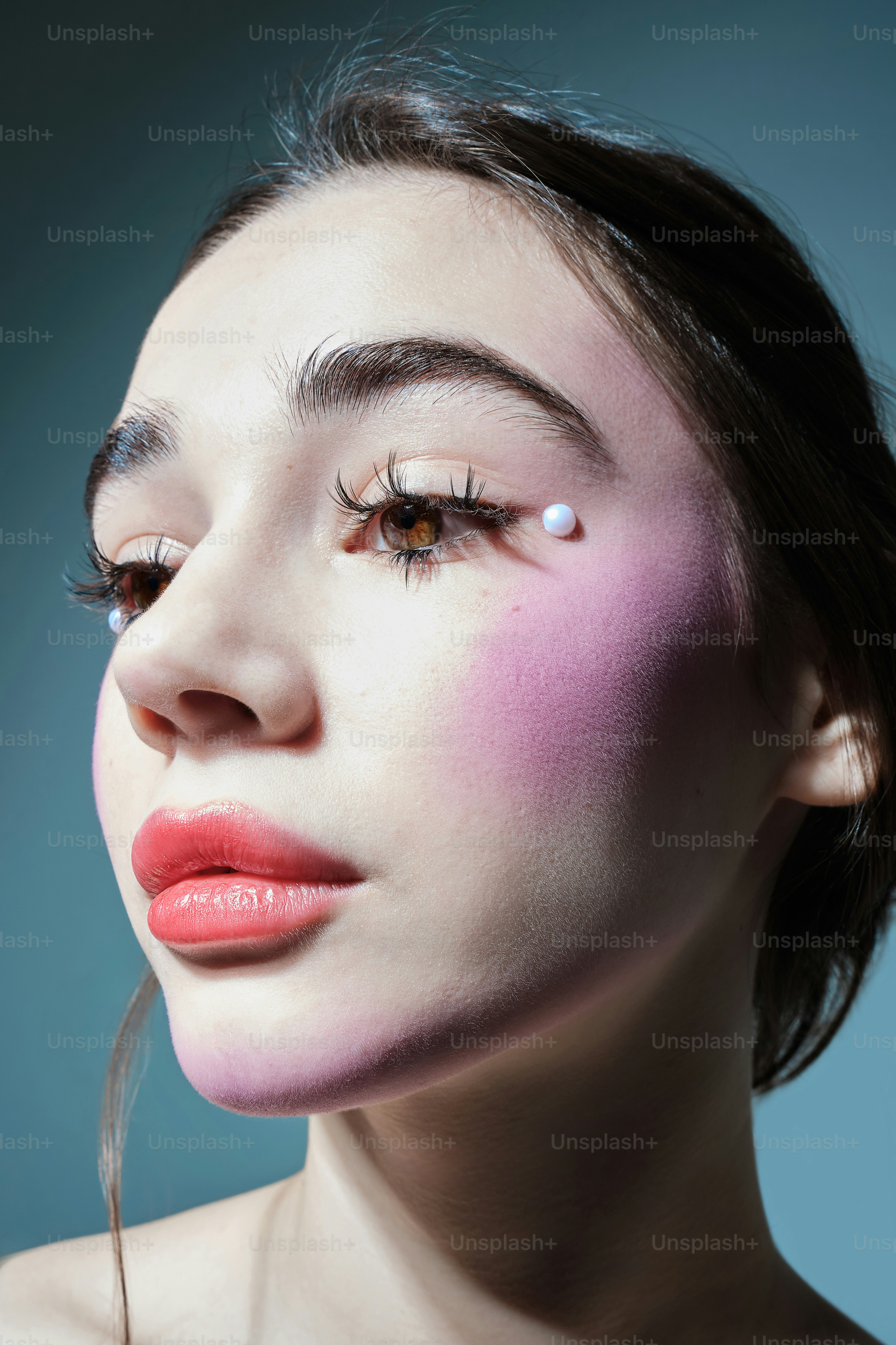 a woman with pink makeup on her face