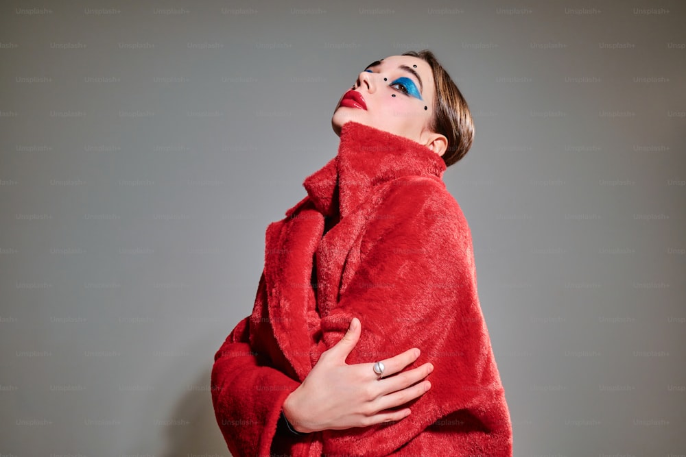 a woman wrapped in a red blanket posing for a picture