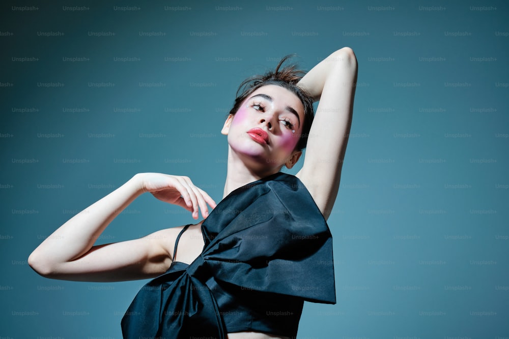 a woman in a black dress posing for a picture