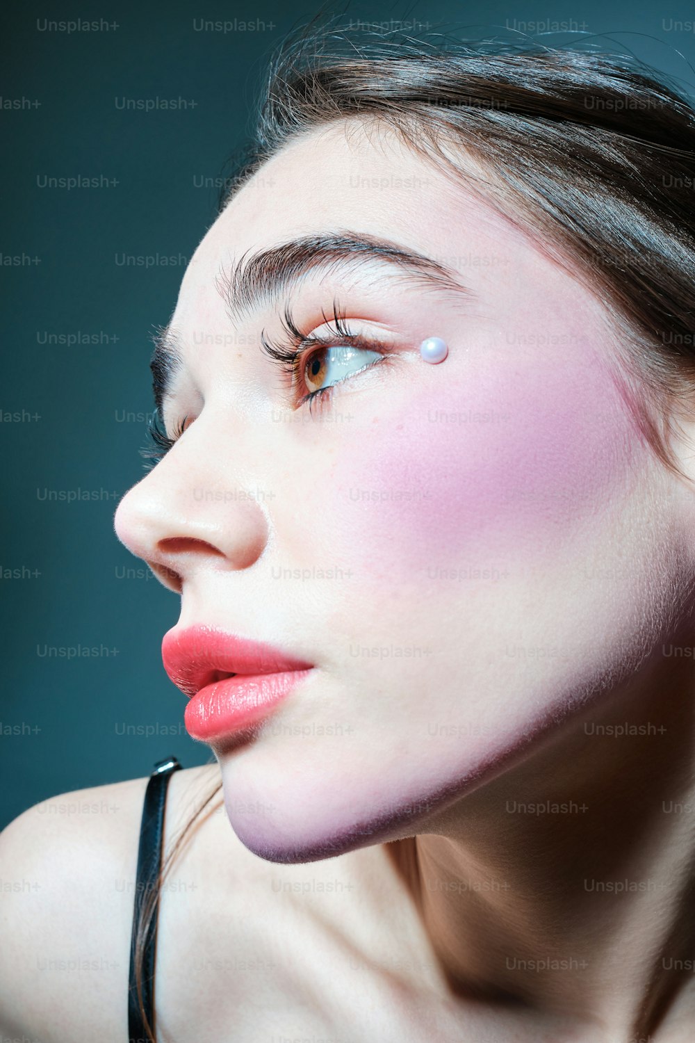 a woman with a pink make up on her face