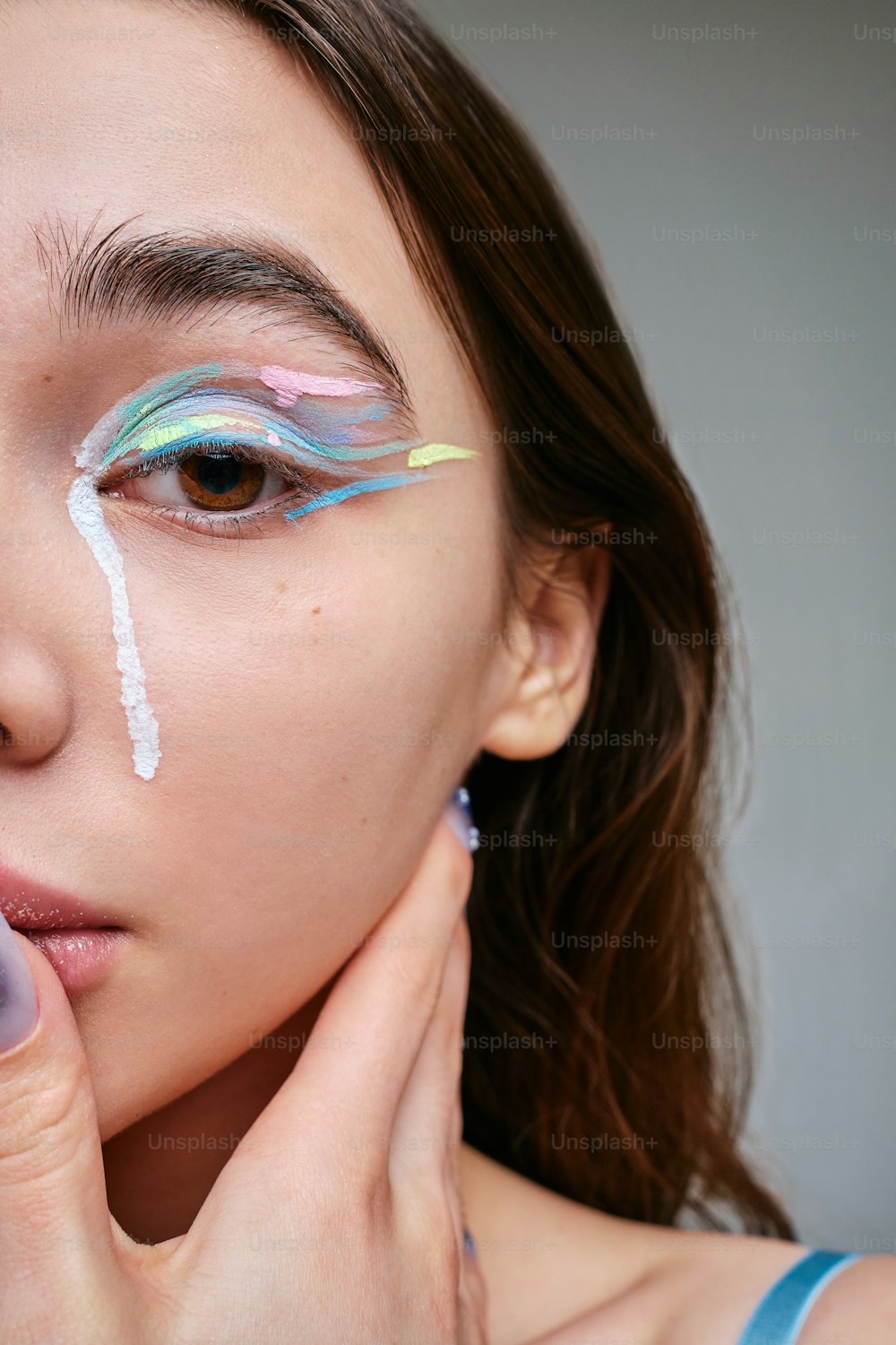 a woman with makeup painted on her face