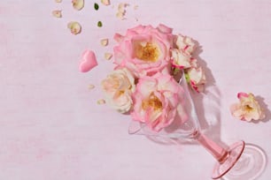 a bouquet of pink roses sitting on top of a table