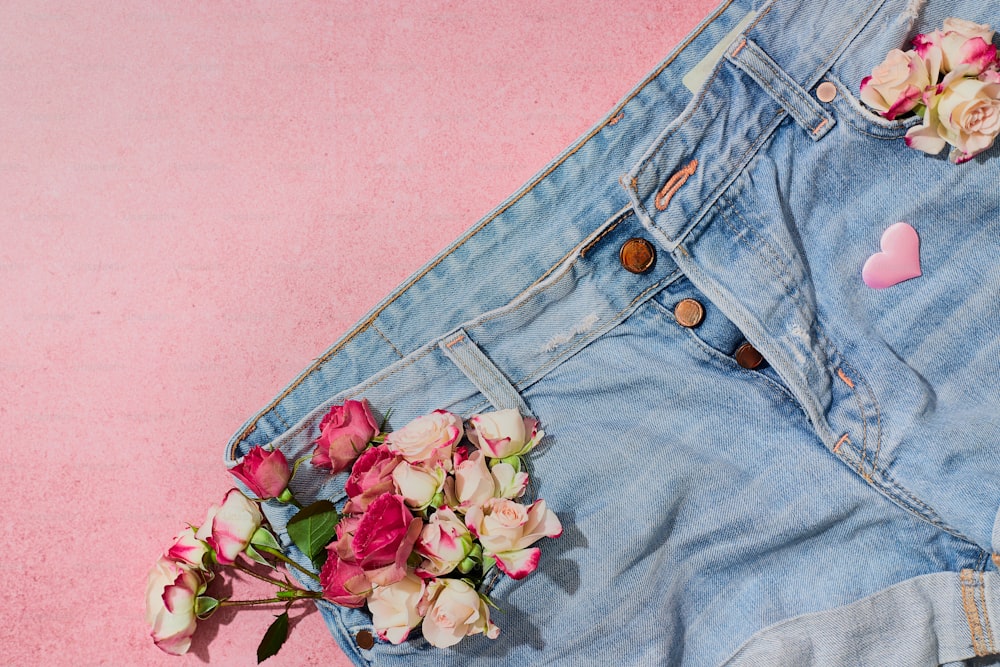a pair of jeans with flowers sticking out of them