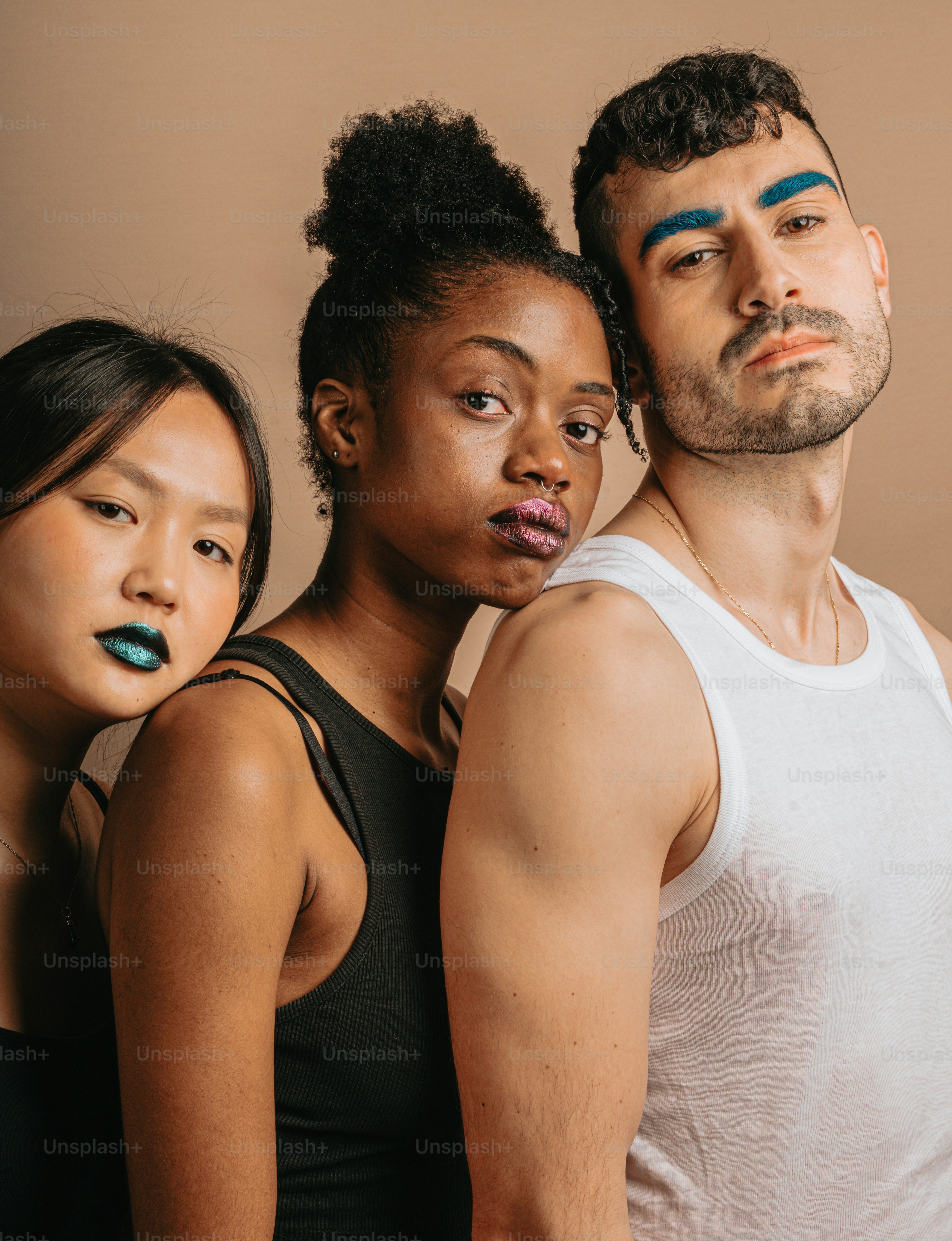 A group of three people standing next to each other photo – Beauty ...