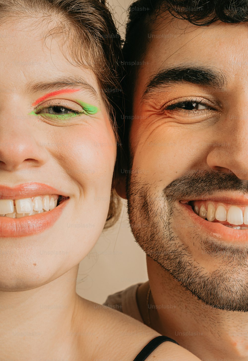 a man and a woman smiling for the camera