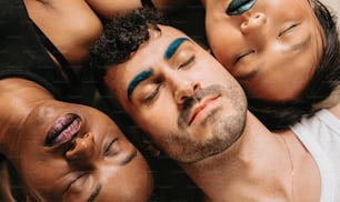 a group of three men laying next to each other