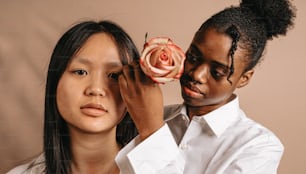 a woman putting a flower on a man's face