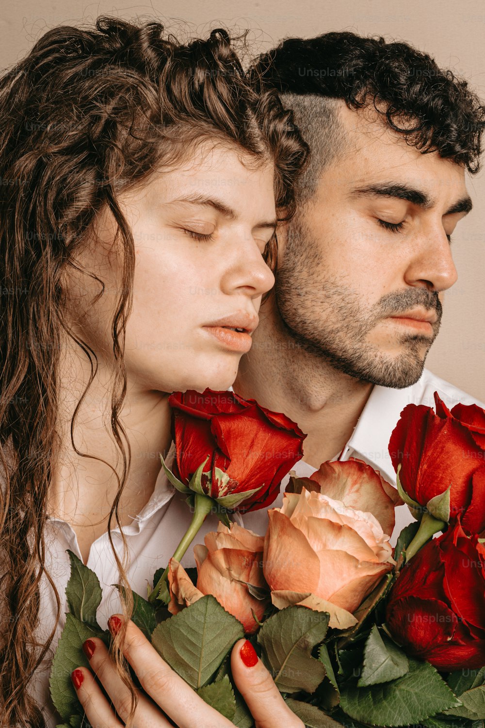 a man and a woman are holding roses