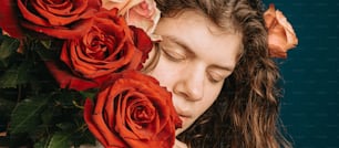 a girl with her eyes closed with roses in front of her