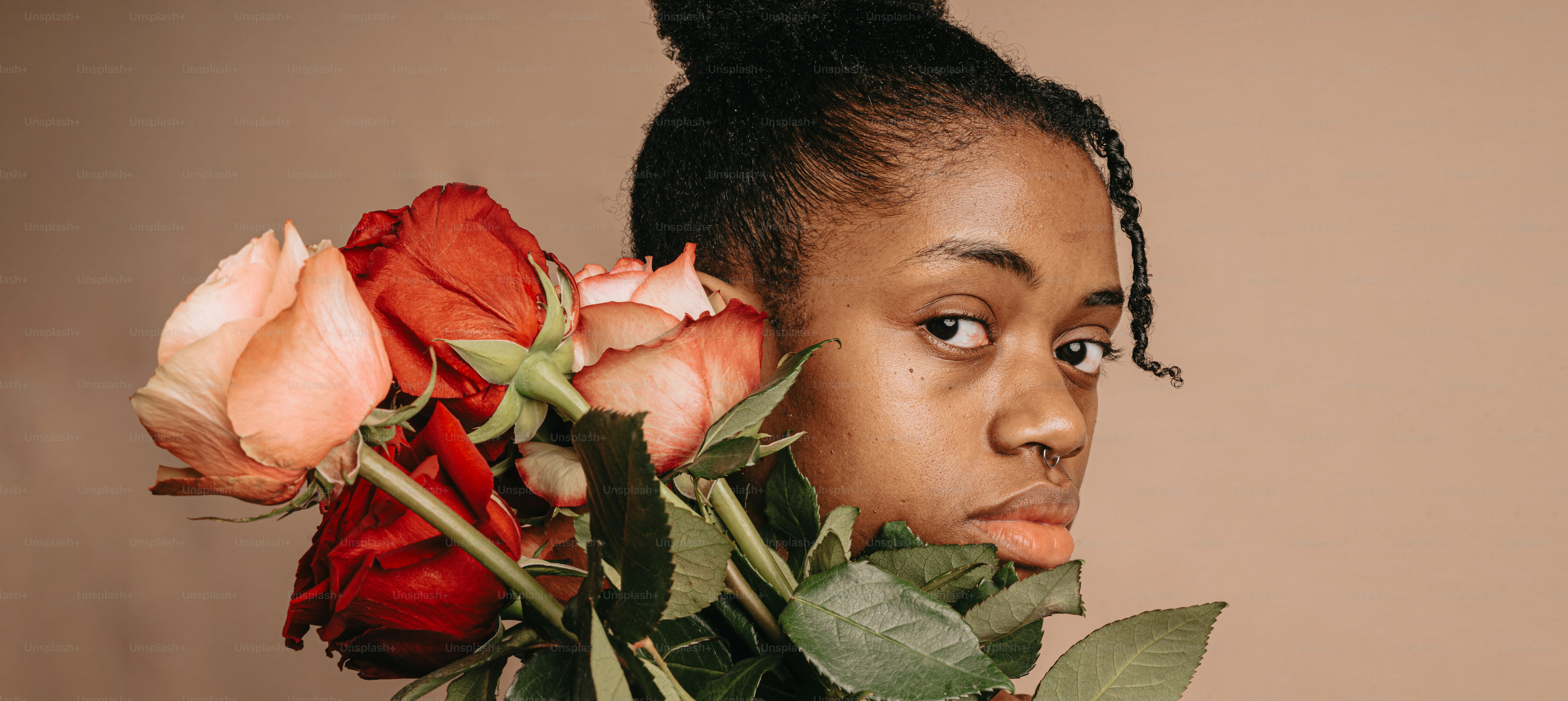 a woman holding a bunch of flowers in her hands
