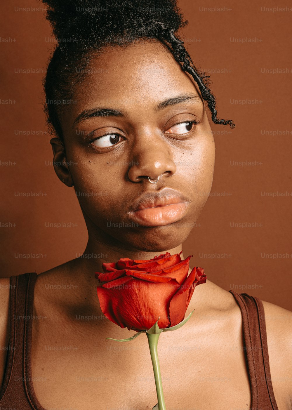 a woman with a flower sticking out of her mouth
