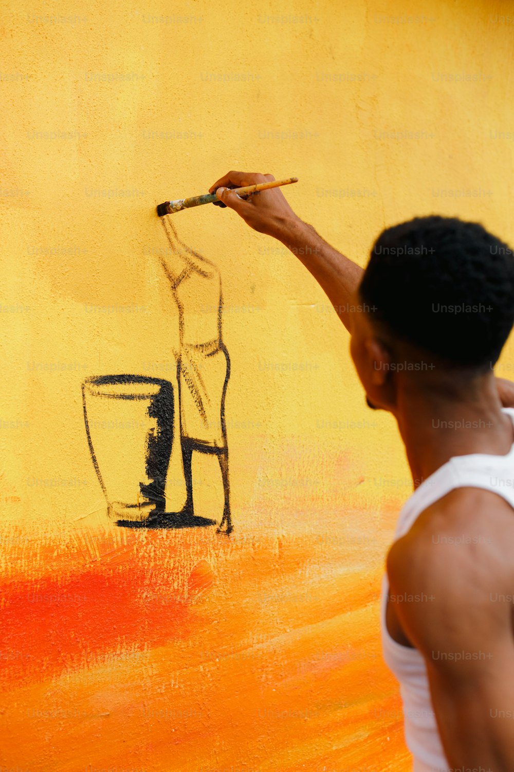 a man is painting a picture on a wall
