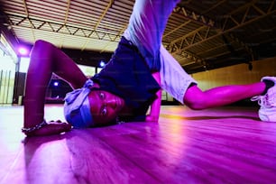 a woman laying on the floor in a gym