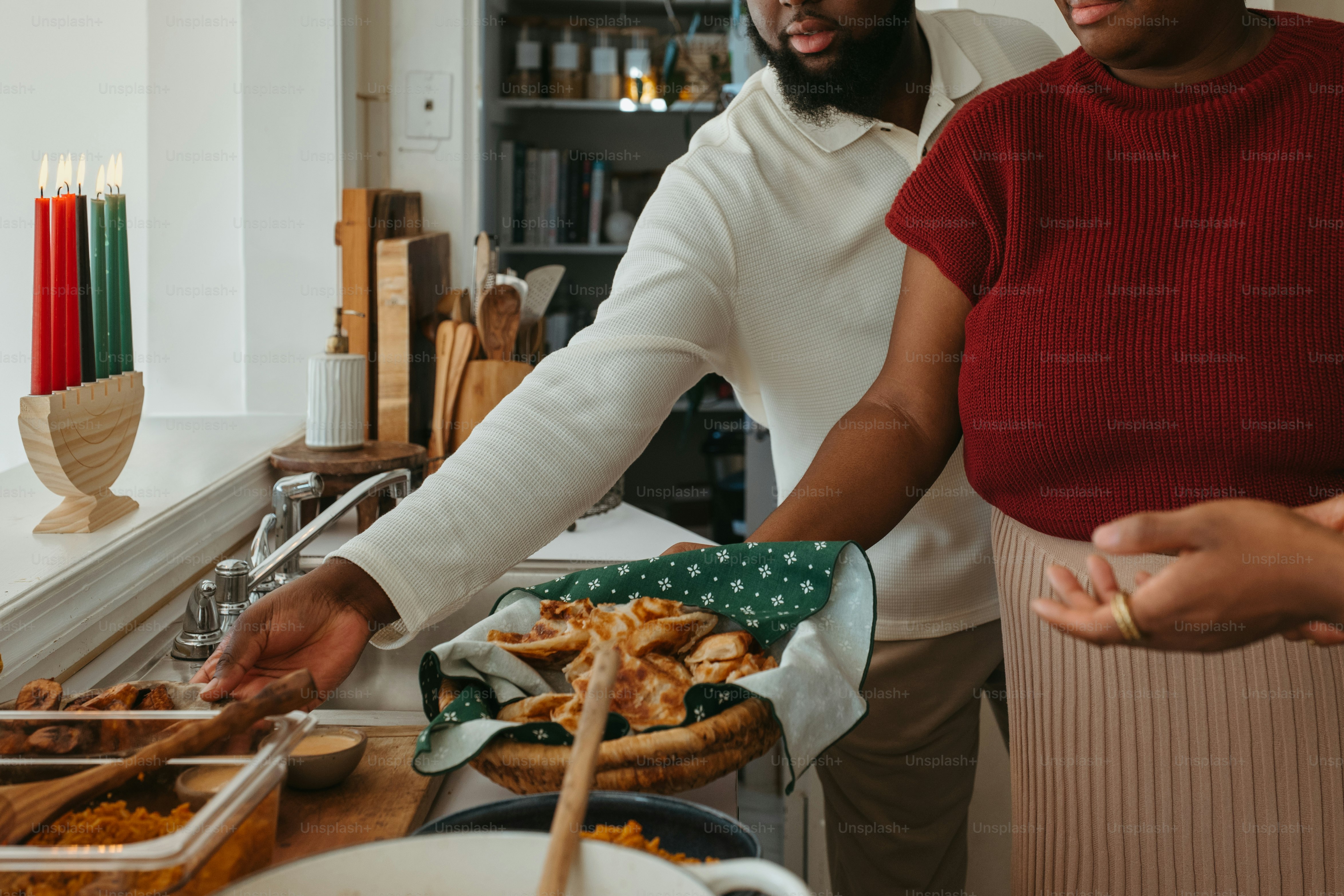 a man and a woman preparing food in a kitchen