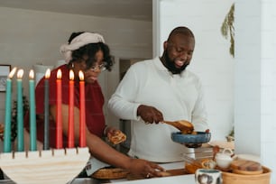 a man and woman preparing food in a kitchen