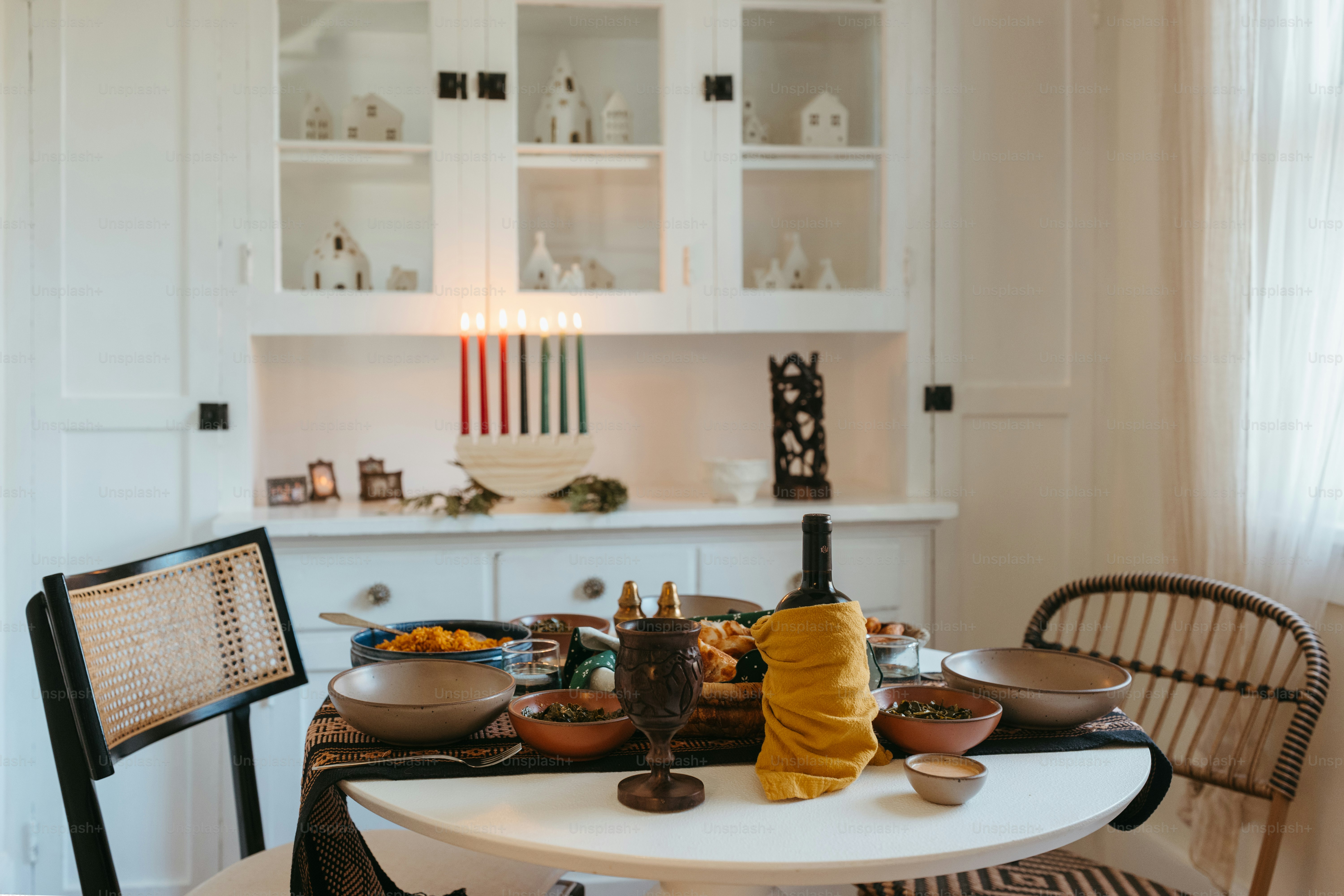 a dining room table with plates and bowls on it