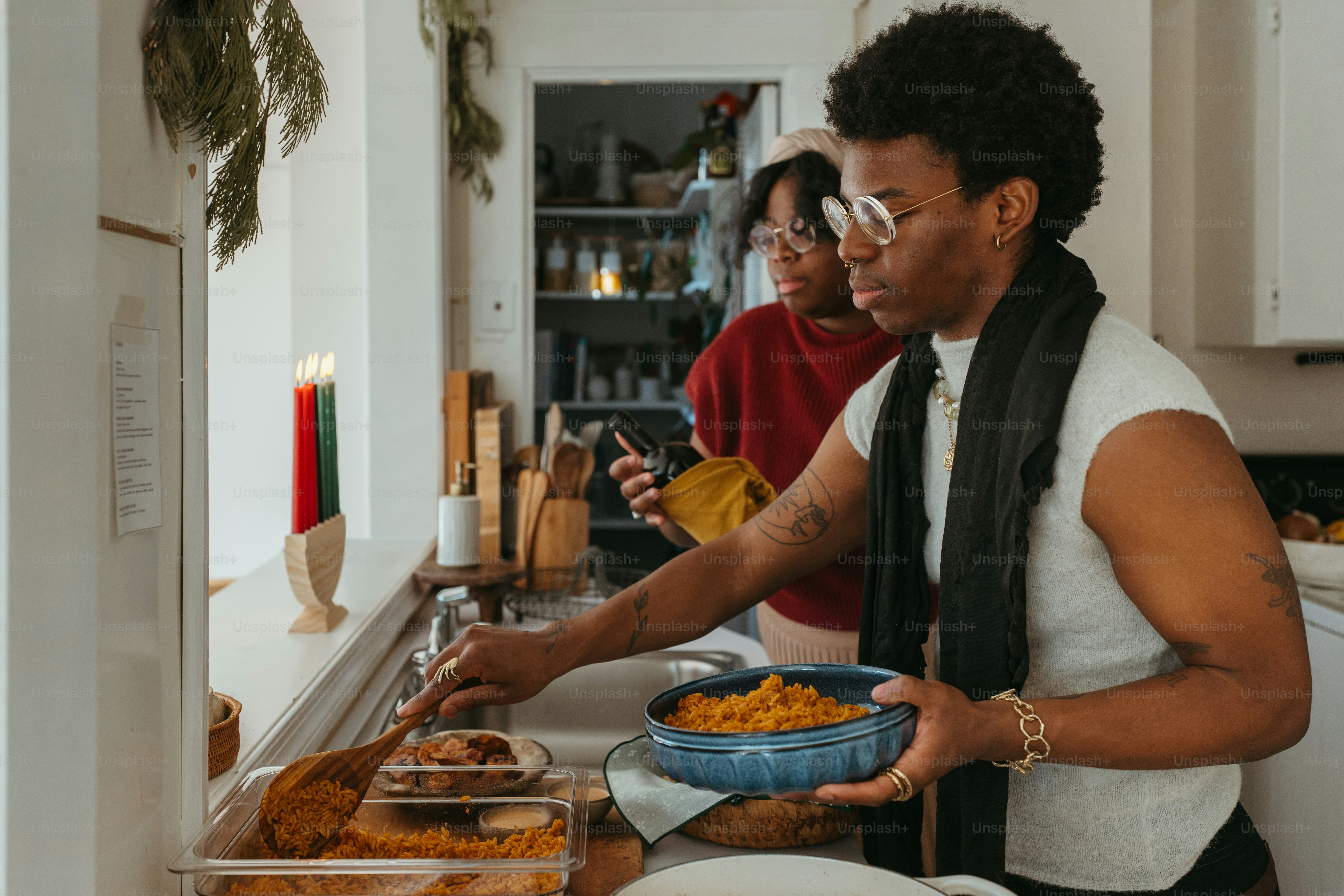 a couple of women standing in a kitchen preparing food