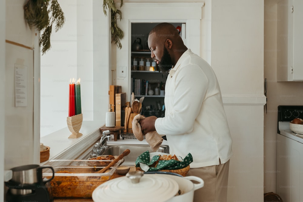 a man standing in a kitchen preparing food