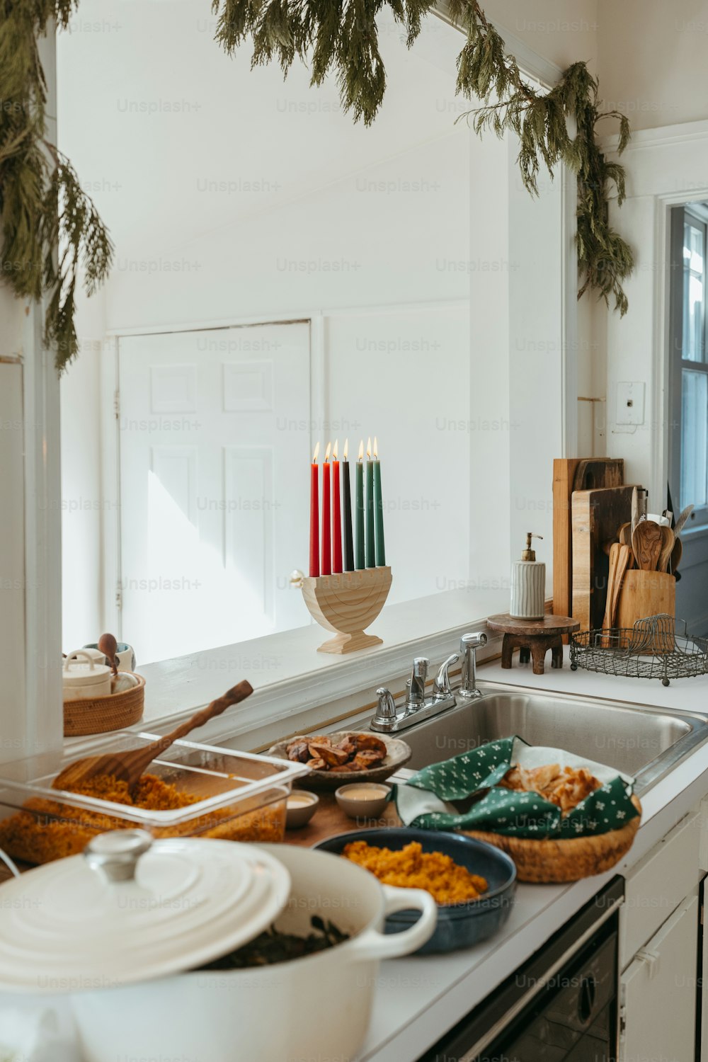 a kitchen counter filled with dishes and candles
