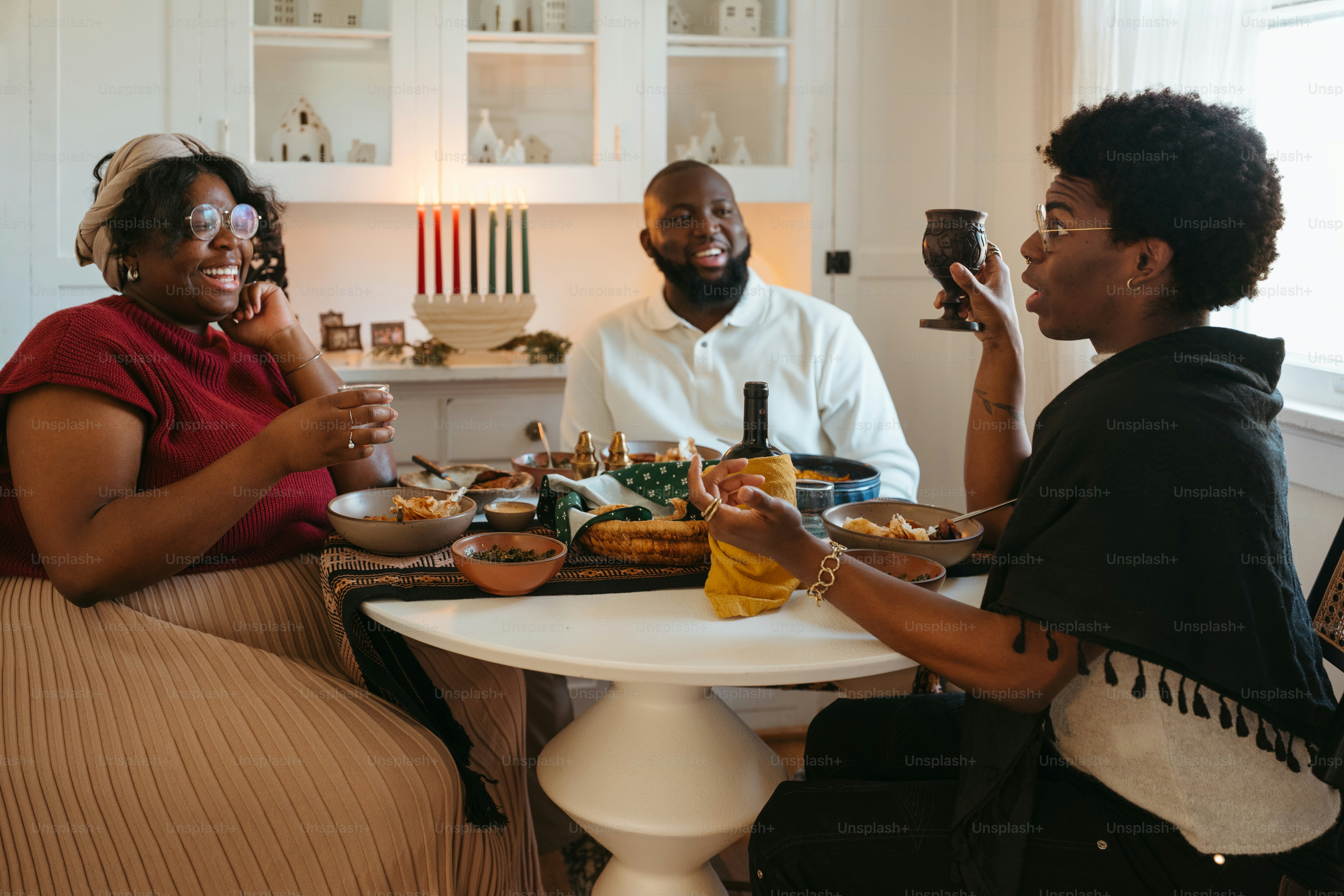 a group of people sitting around a table eating food