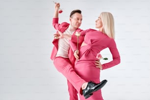 a man and woman dressed in pink posing for a picture