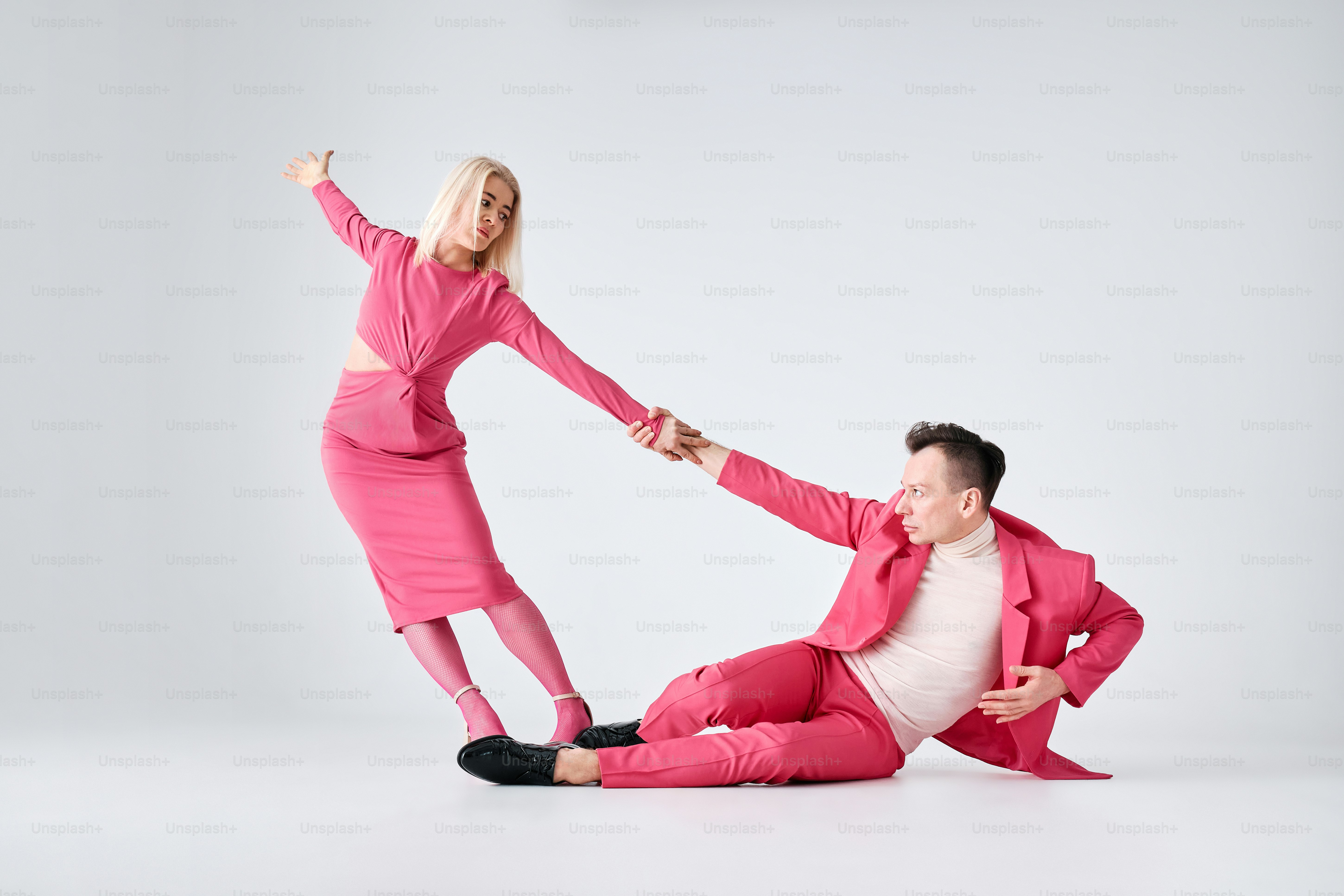 a man in a pink suit and a woman in a pink dress