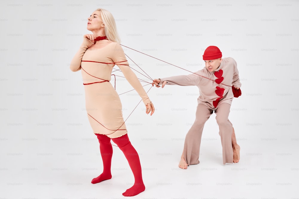 a woman pulling a man on a string