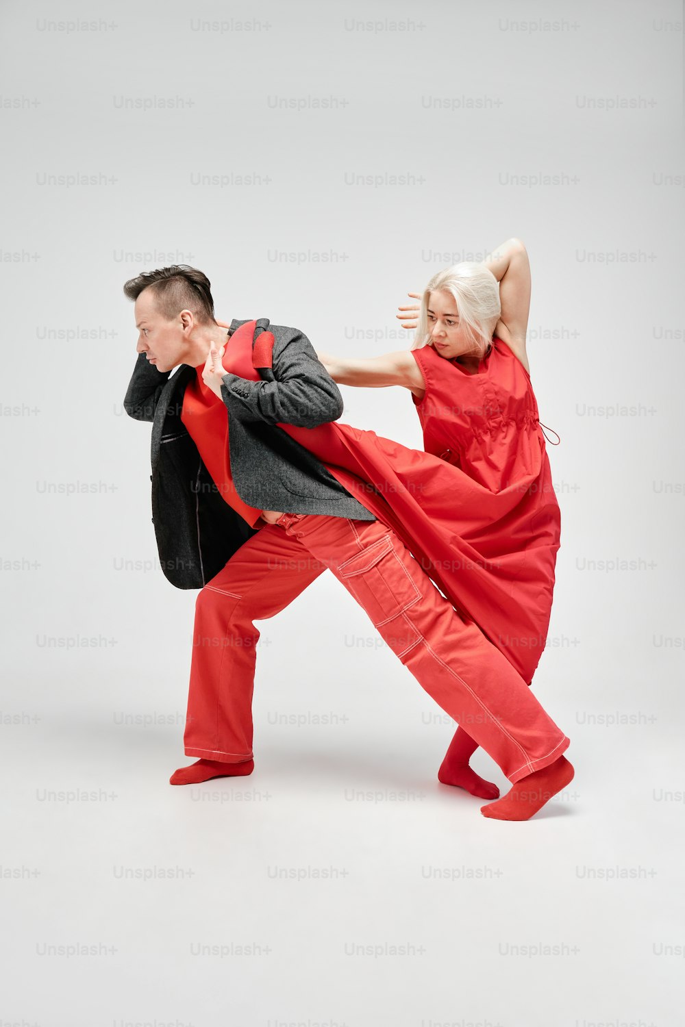 a man and a woman are performing a dance