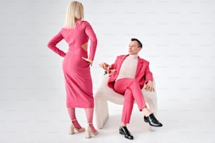 a man in a pink suit and a woman in a white dress