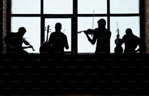 a group of people standing next to each other in front of a window