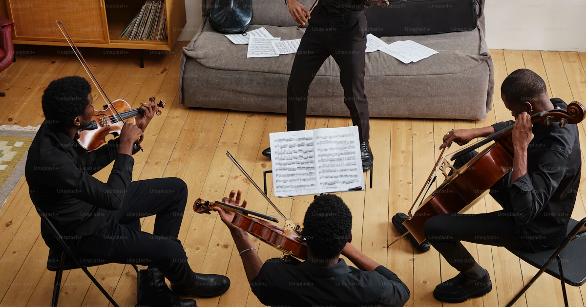 Community Playing Instruments A group of people playing instruments in a room photo – Violin Image on ...
