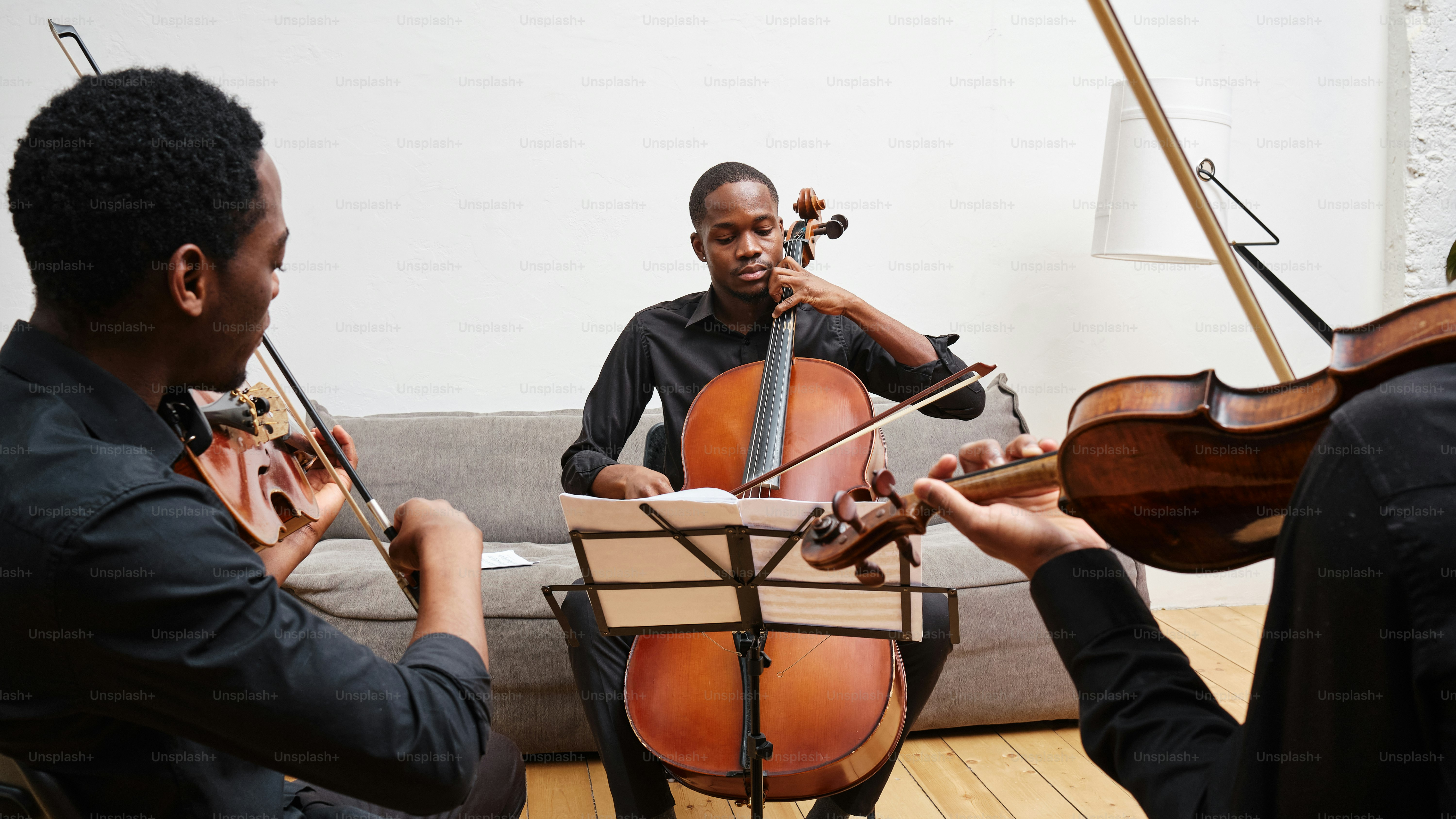 a group of men playing musical instruments in a living room