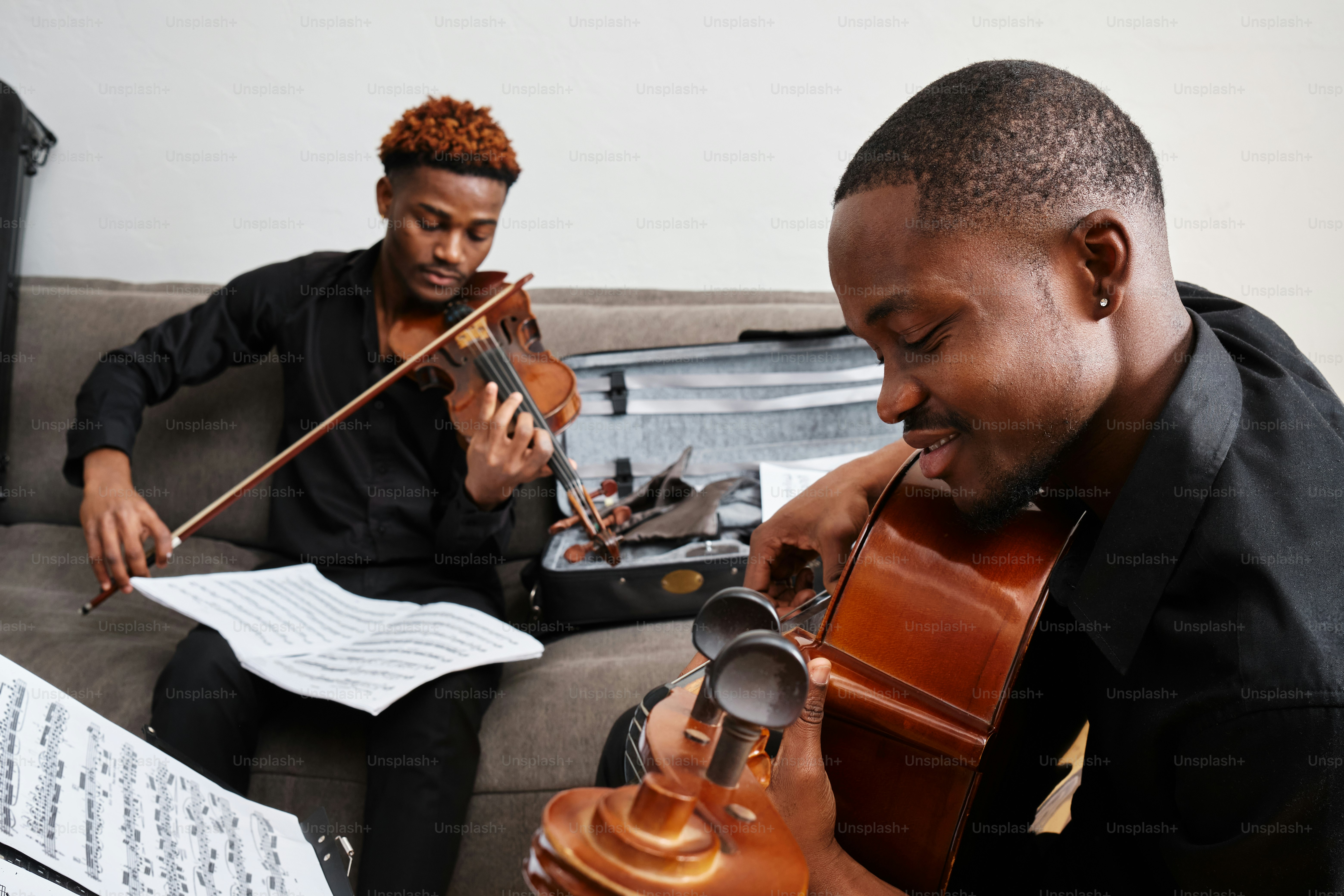 a couple of men sitting on top of a couch
