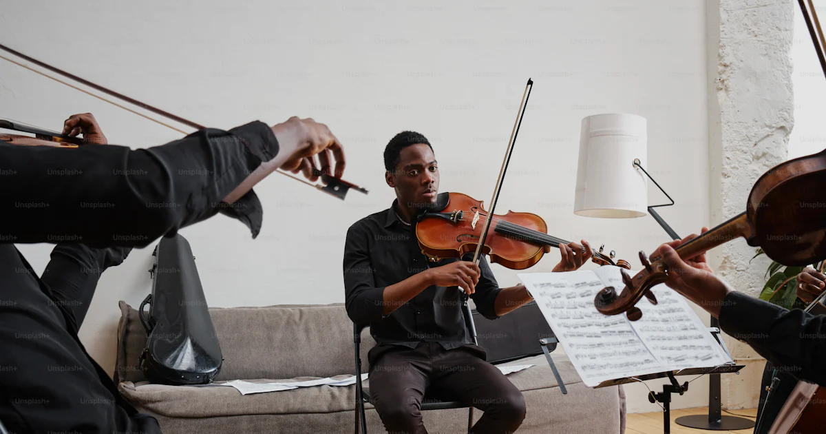People Instruments A group of people playing instruments in a room photo – Violin Image on ...