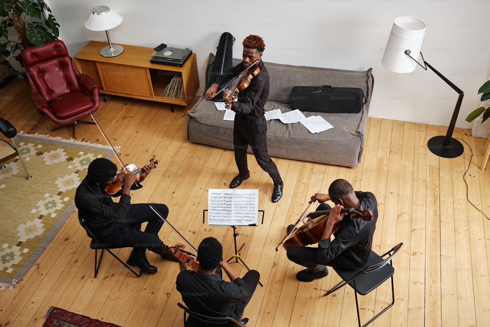 a group of people playing instruments in a living room