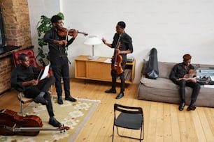 a group of men playing instruments in a living room