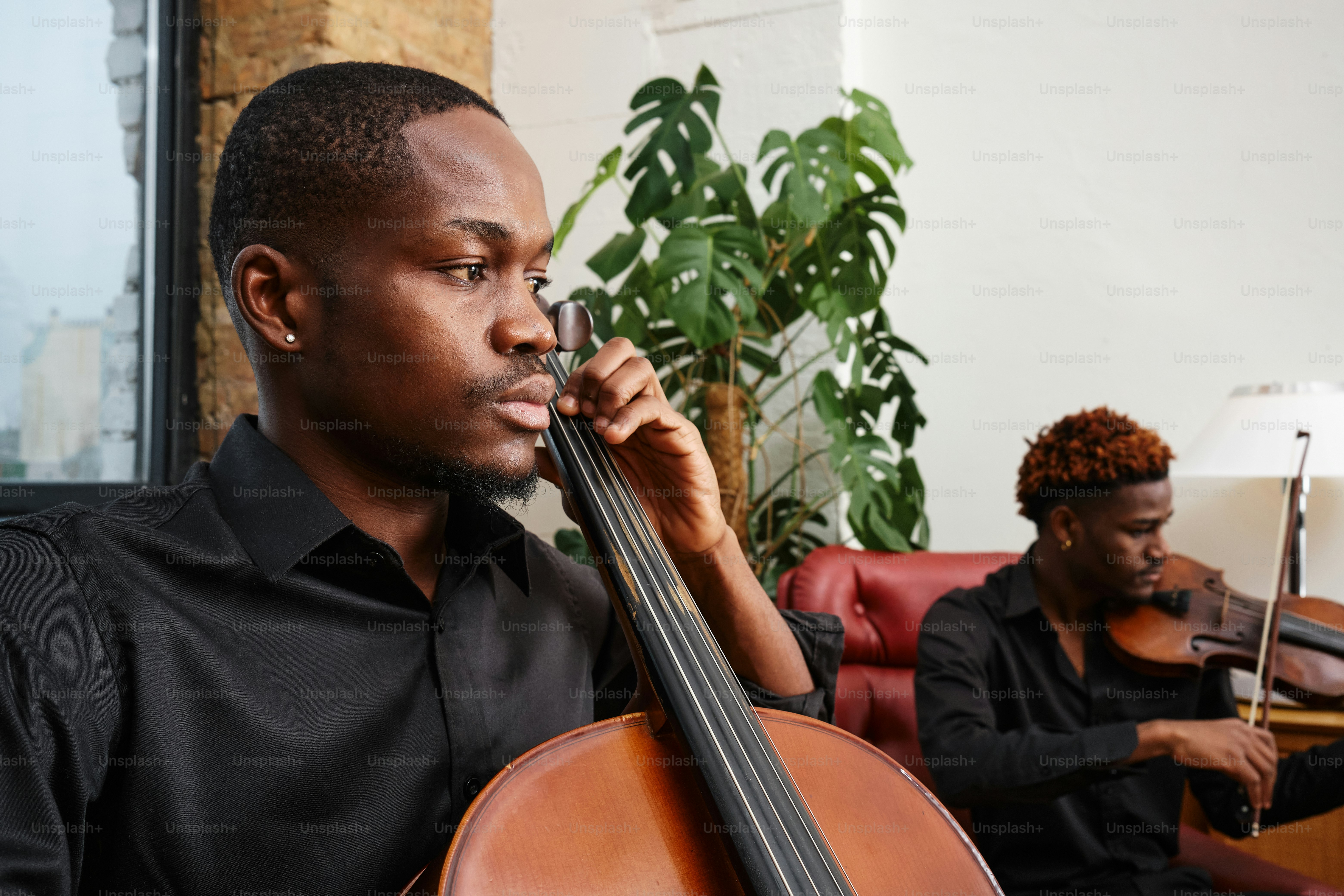 A group of men playing musical instruments in a living room photo ...