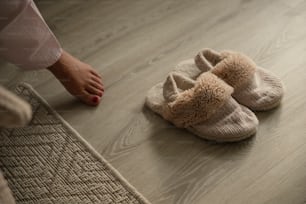 a pair of slippers sitting on top of a wooden floor