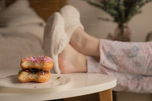 two donuts sitting on a plate on a table
