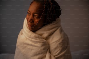 a woman wrapped in a blanket with her eyes closed