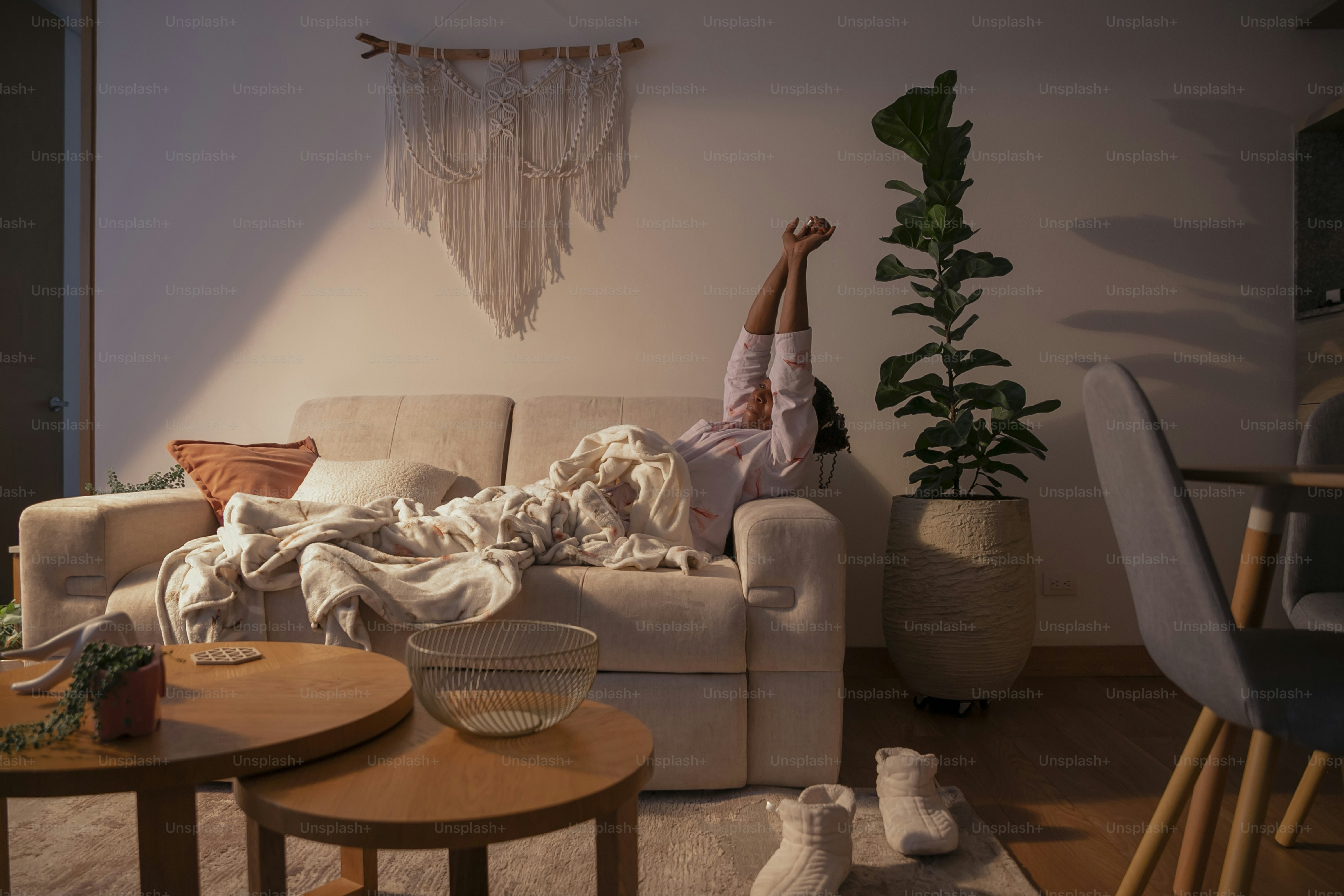a person laying on a couch in a living room