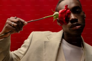 a man with a rose in his mouth