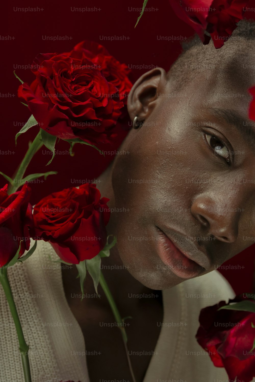 a man with a bunch of roses around his neck