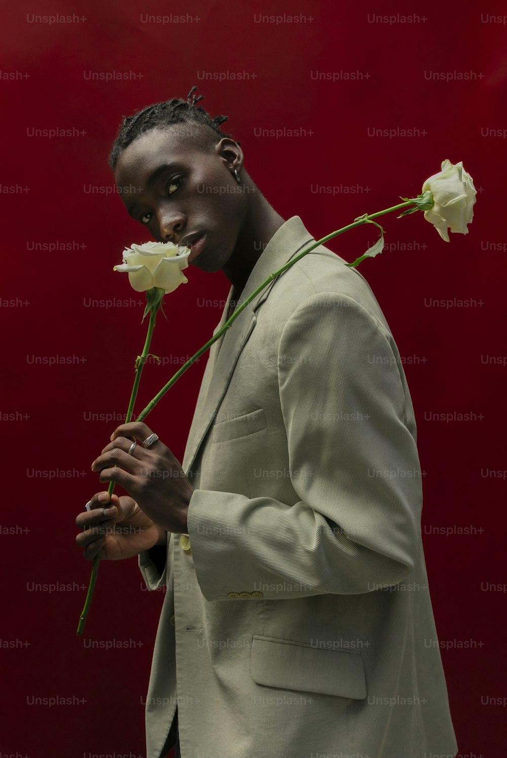 a man in a suit holding a flower