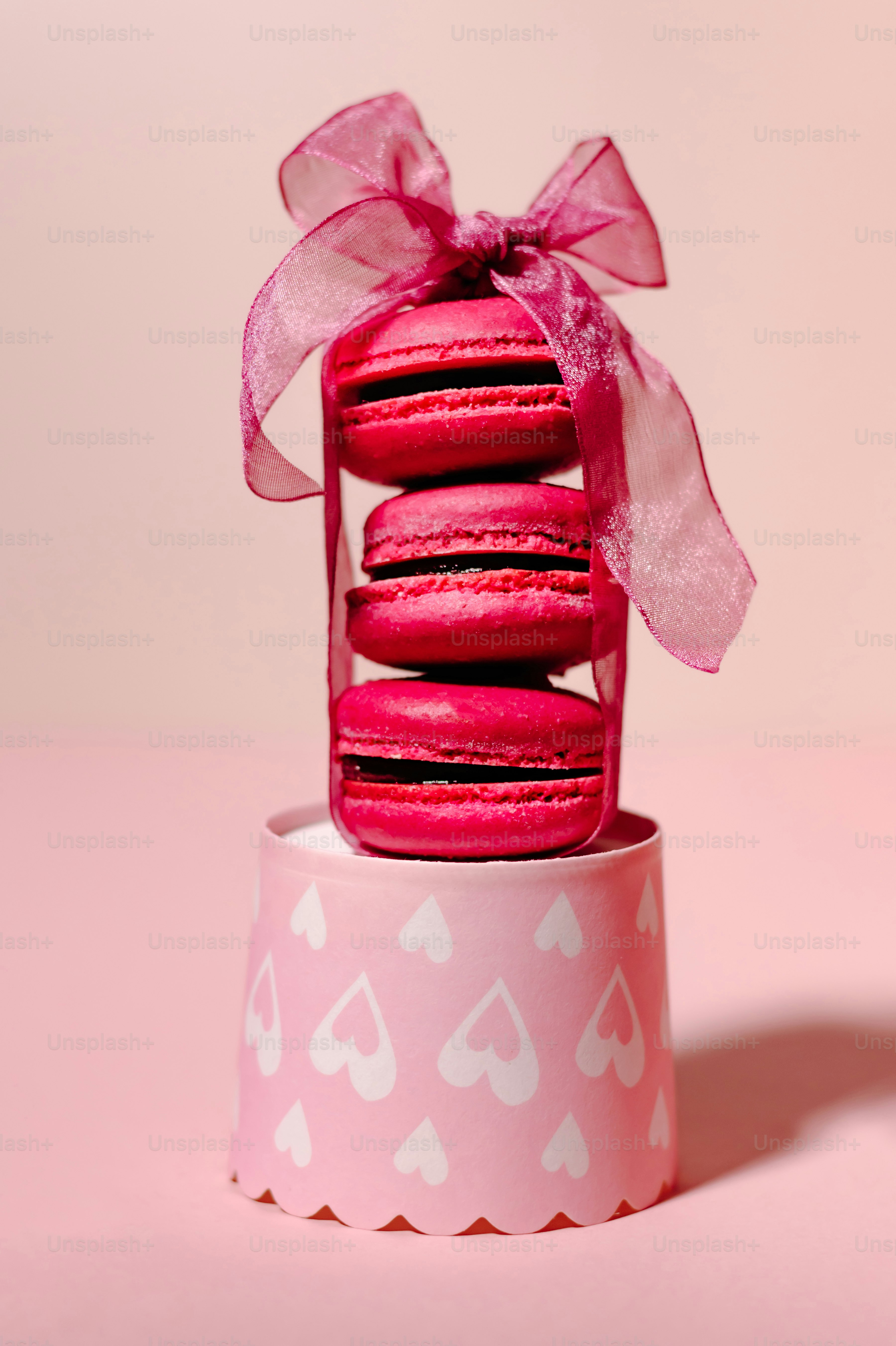 Stack of pink macarons tied with ribbon photo – Food Image on Unsplash